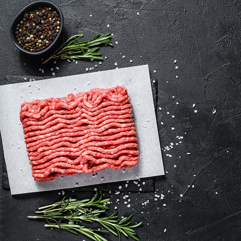 Raw minced beef on a black background