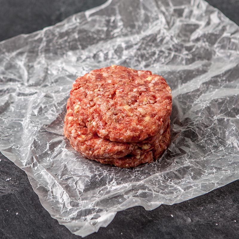 A stack of raw pork burgers