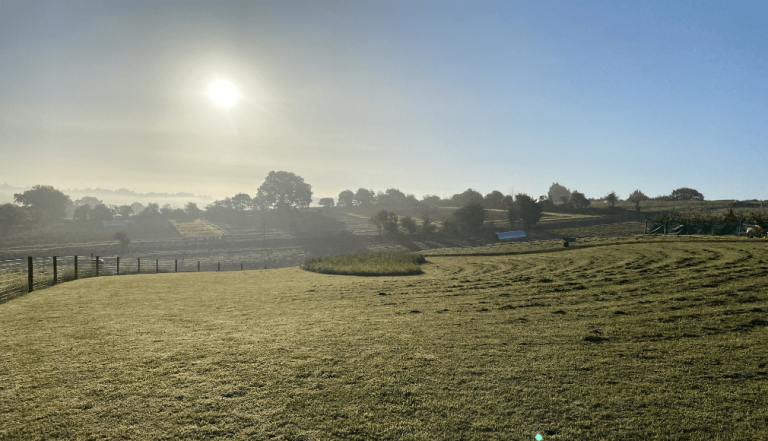 View of the sun rising over the Dorset countryside at The Story Pig, Dorset